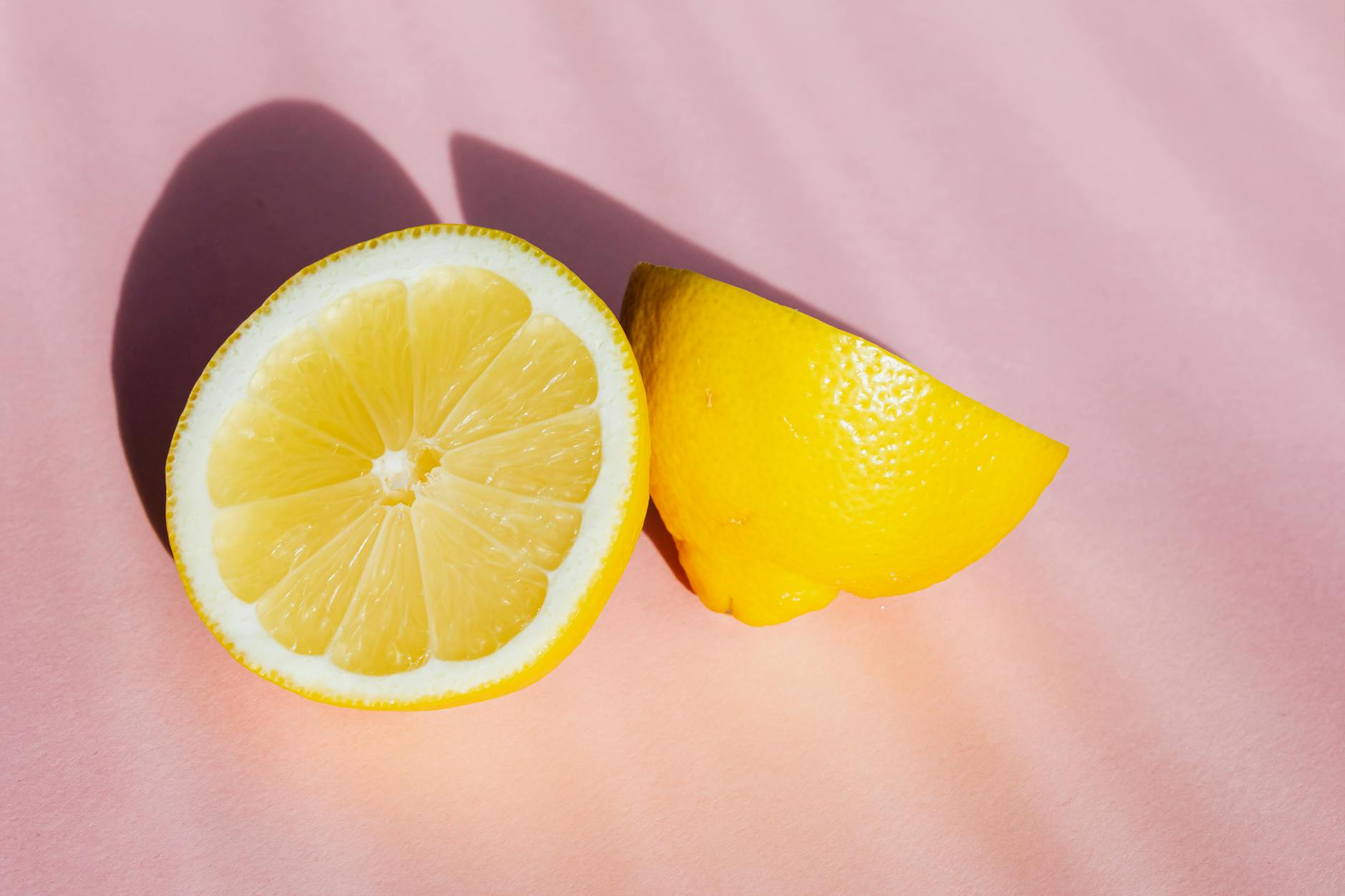Two fresh lemons on a white background representing the lemon clitoral vibrator