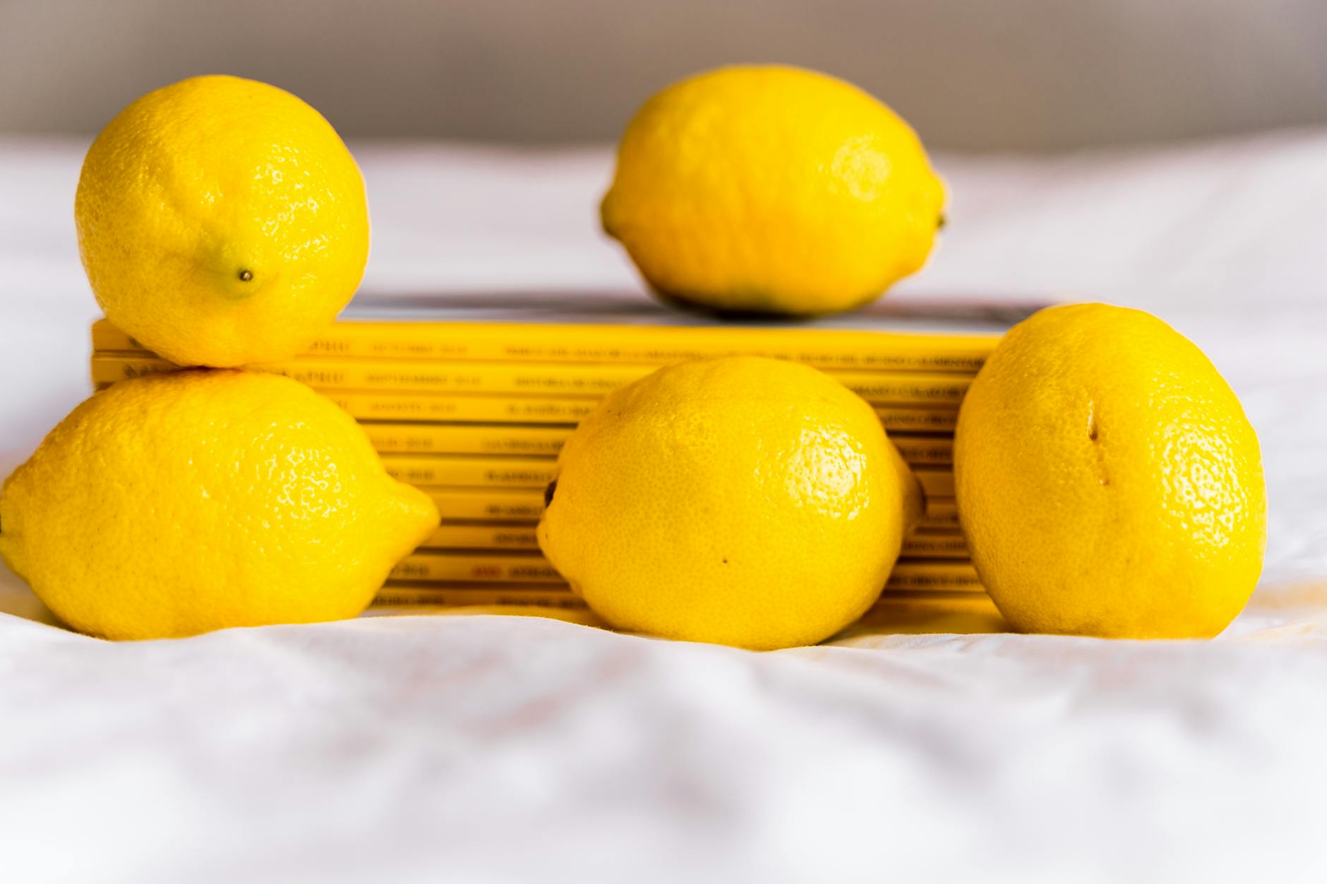 Two vibrant lemons placed against a minimalistic white background, symbolizing freshness and new beginnings